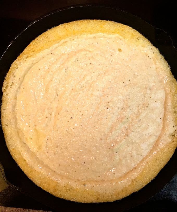 Batter just added to a hot cast-iron skillet before placing it in the oven. 
