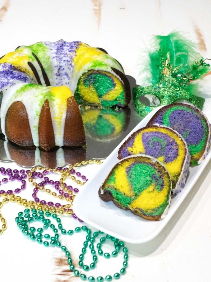 Lemon Bliss Bundt Cake with with slices showing yellow, green and purple swirled throughout the cake..