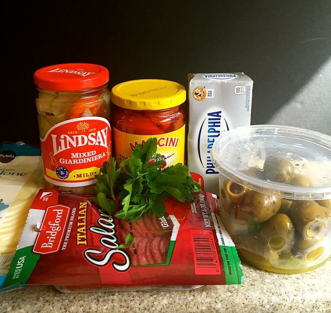 Muffuletta Dip ingredients including salami, giardiniera, cream cheese, and olives