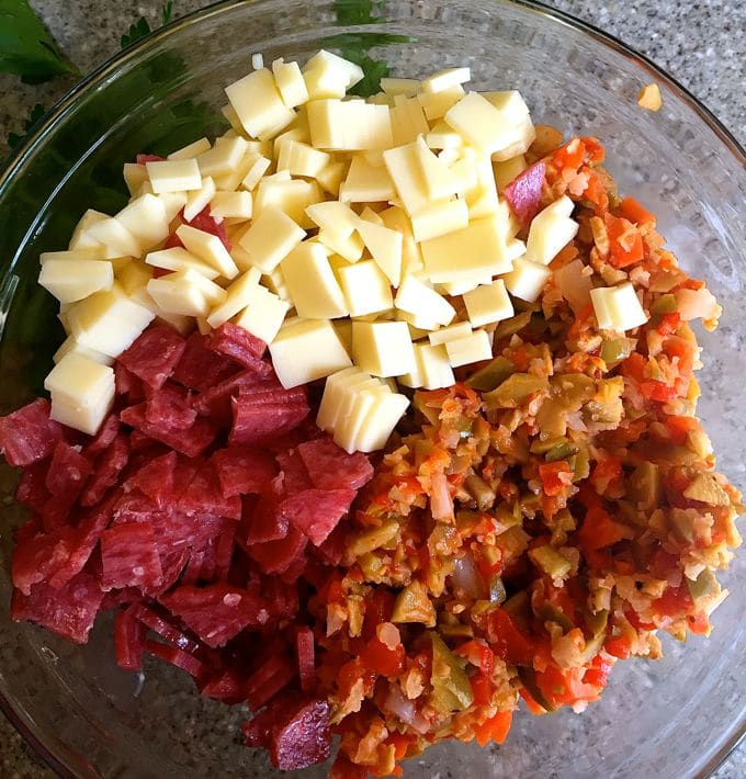 Mixing all of the ingredients in a bowl to make a dip.