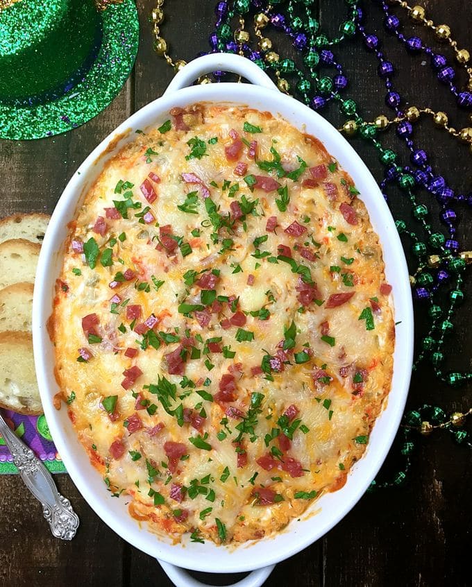 Easy Mardi Gras Hot Muffuletta Dip hot out of the oven with toasted bread rounds for dipping