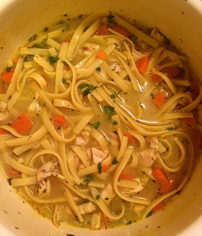 Fettuccine, chicken, and chopped parsley added to the dutch oven.
