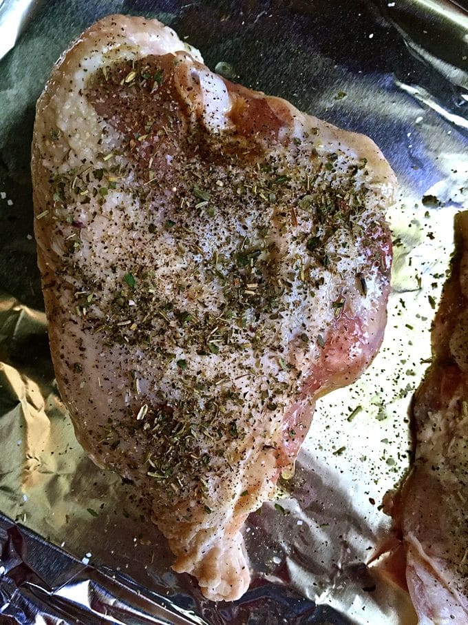 Chicken breast skin side up on aluminum foil with salt, pepper, and Herbs de Provence.