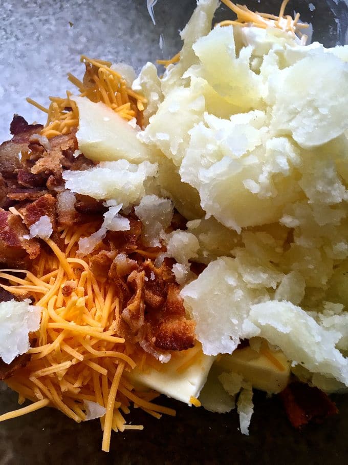 The pulp of the potato with shredded cheese and crumbled bacon.