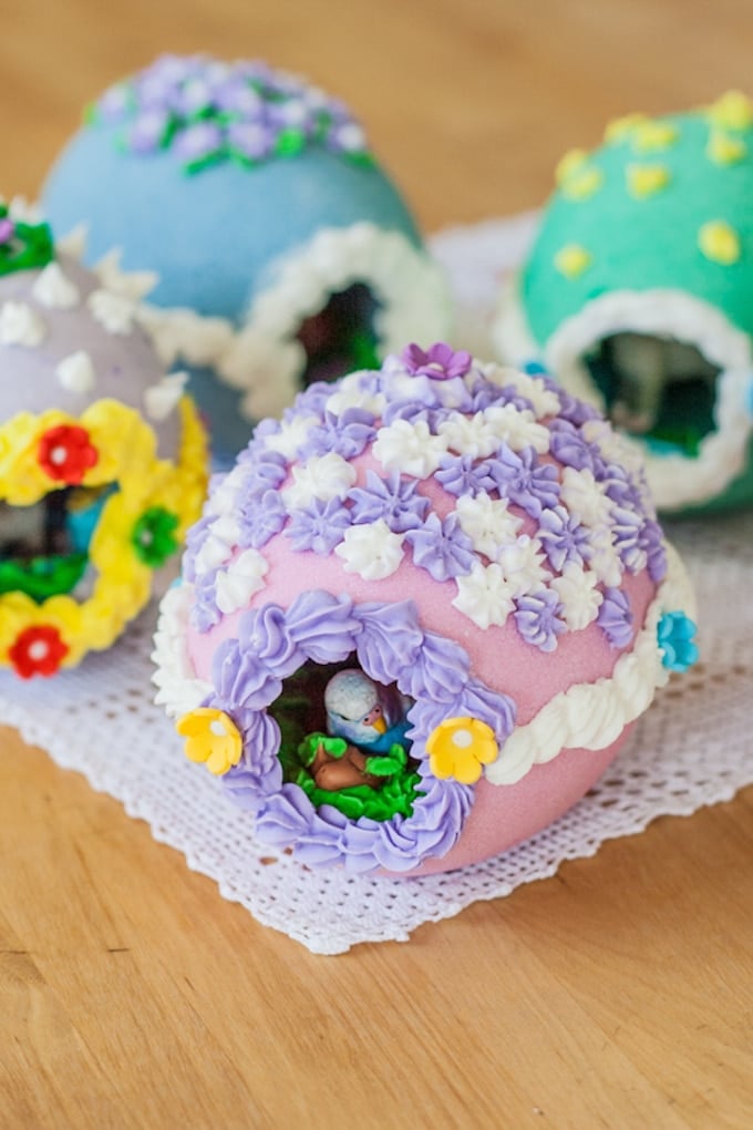 Decorated Easter eggs in different colors filled with candy. 