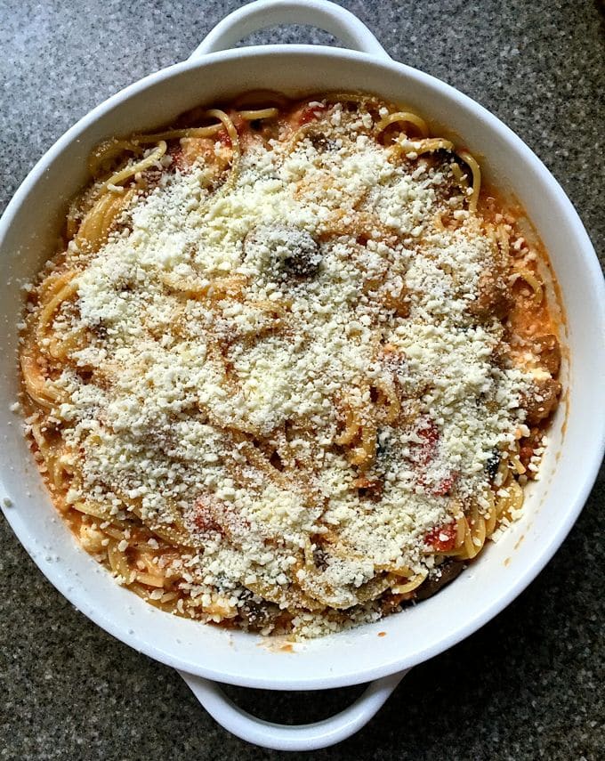 Easy Baked Spaghetti Pie Casserole in a white baking dish and ready for the oven