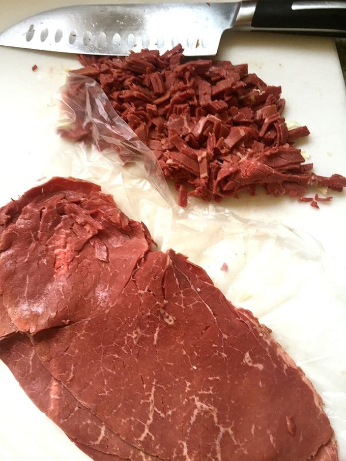 Chopping up corned beef for Corned-Beef-and-Cabbage-Egg-Rolls.