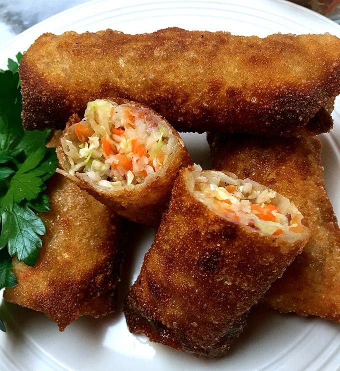 Corned Beef and Cabbage Egg Rolls on a plate garnished with parsley.