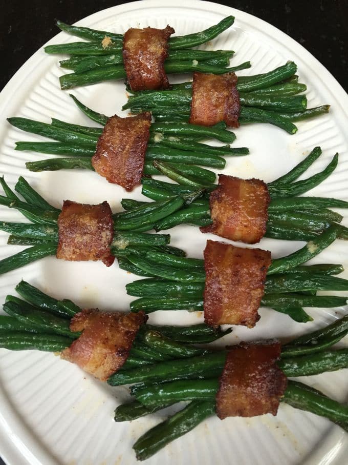 Green Bean Bundles with Bacon on a white serving platter. 
