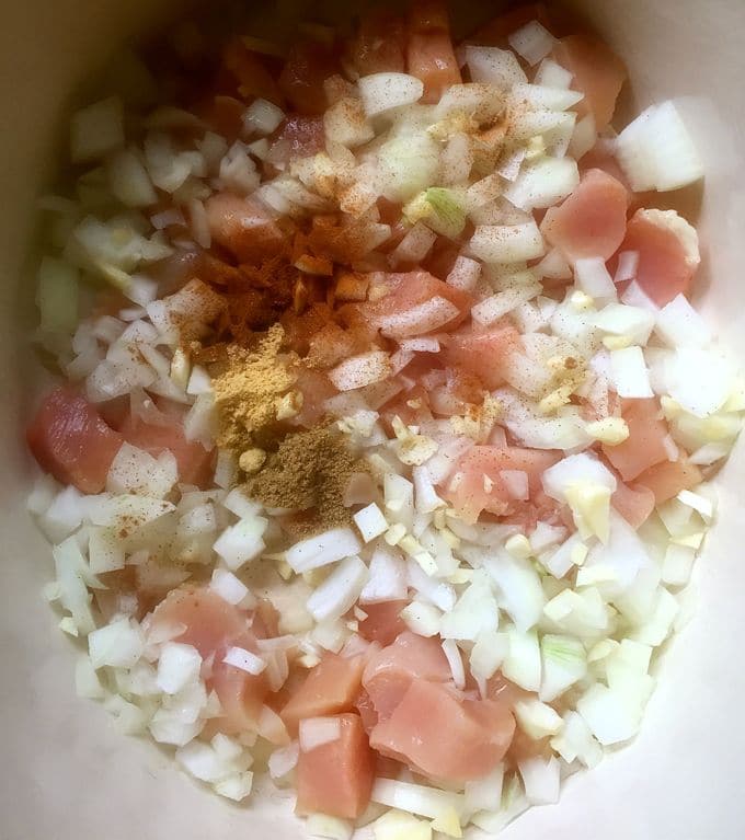 Chicken, chopped onions, garlic, ginger, coriander, cinnamon and saffron threads in a large Dutch oven