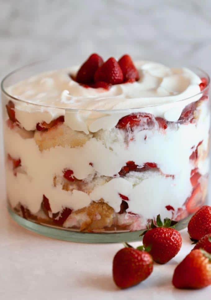 Strawberry Trifle with Angle Food Cake in a trifle dish with fresh strawberries, angel food cake, and whipped cream