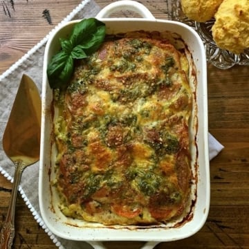 A white casserole dish full of prosciutto breakfast casserole.