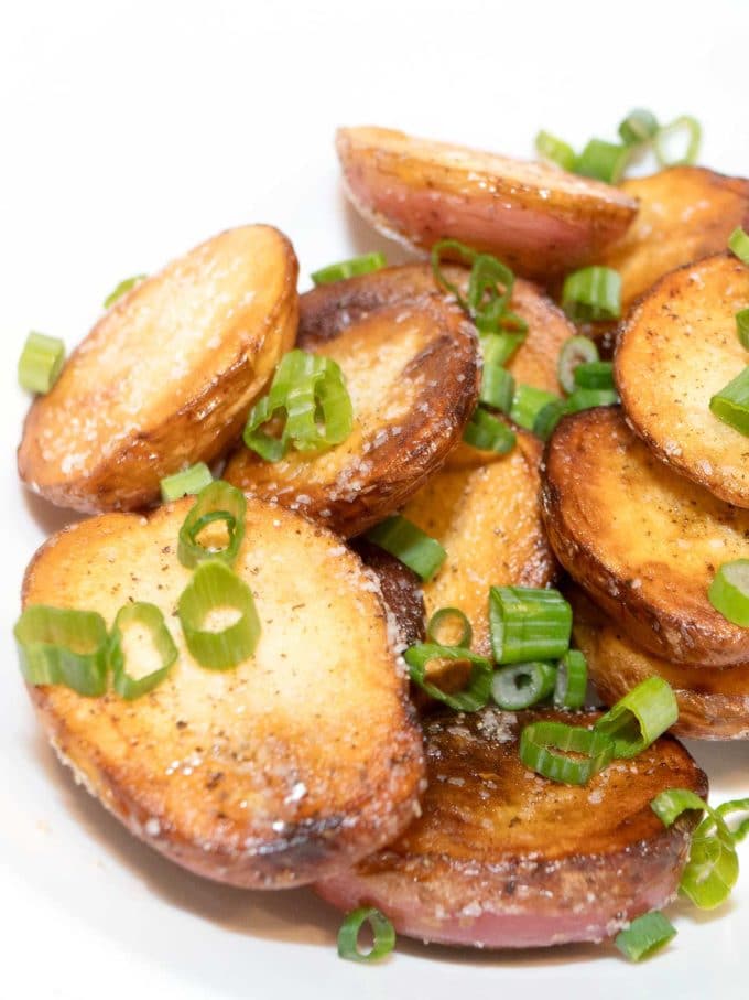 Stove top potatoes garnished with green onions.