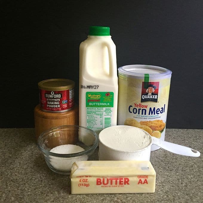 Containers of buttermilk, flour, cornmeal, butter, and baking powder.