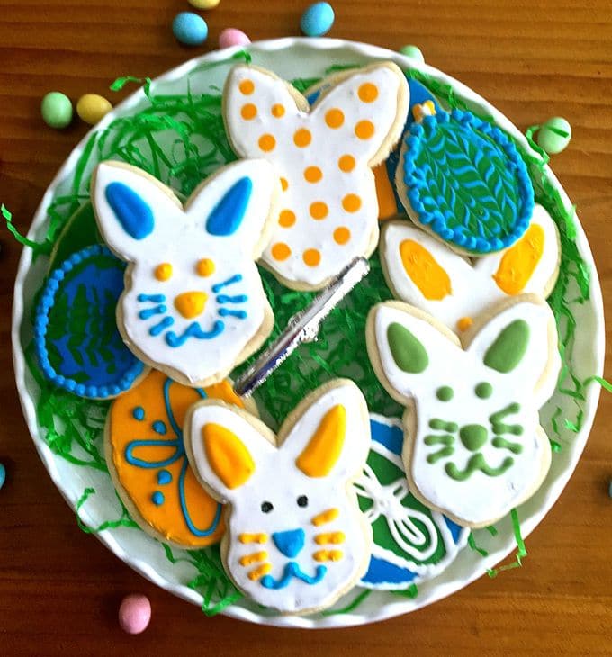 A plate full of decorated Easter egg and bunny rabbit cookies.