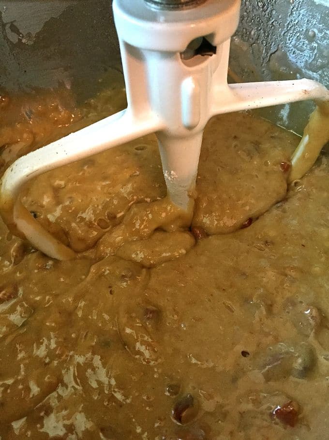 Cake batter being mixed in a bowl of an electric mixer.