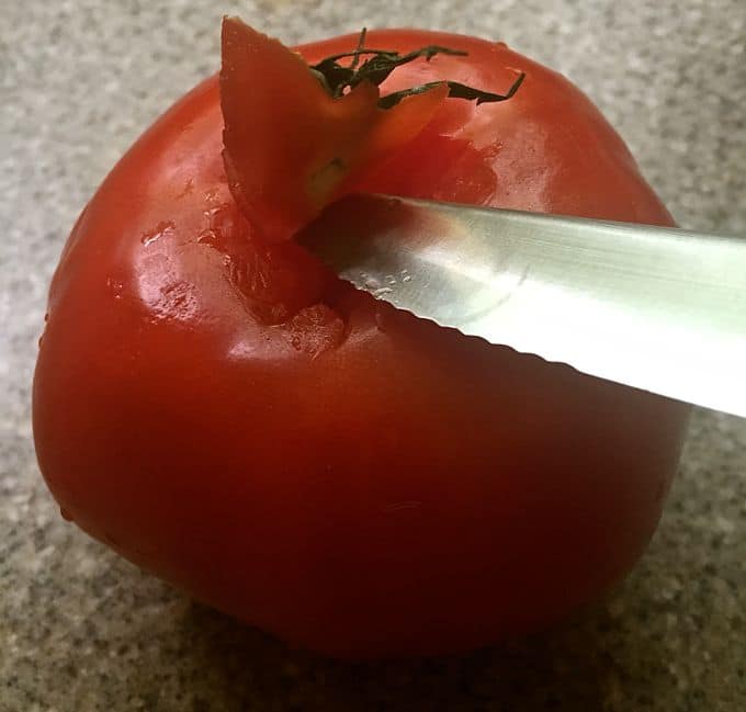 Southern Spicy Tomato-Cheese Grits coring a tomato.