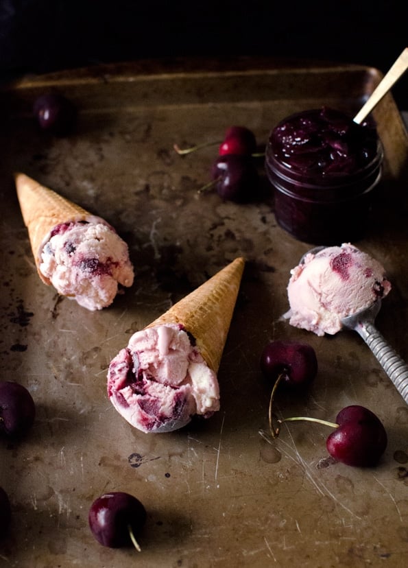 Sugar cones full of Black Cherry Buttermilk Ice Cream on a cookie sheet. 