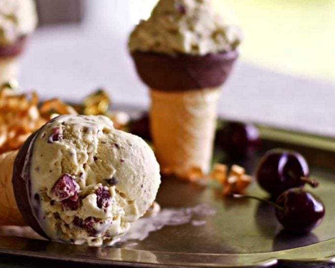 Two ice cream cones full of Dark Chocolate Cherry Custard Ice Cream.