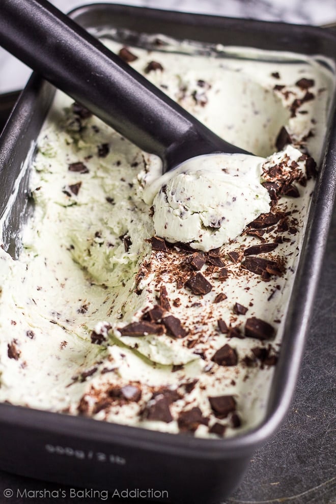 No Churn Mint Chocolate Chip in a metal loaf pan with an ice cream scoop.