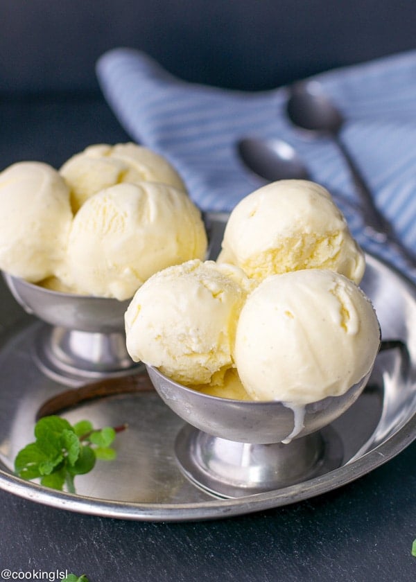 Metal bowls full of scoops of Vanilla Bean Ice Cream.