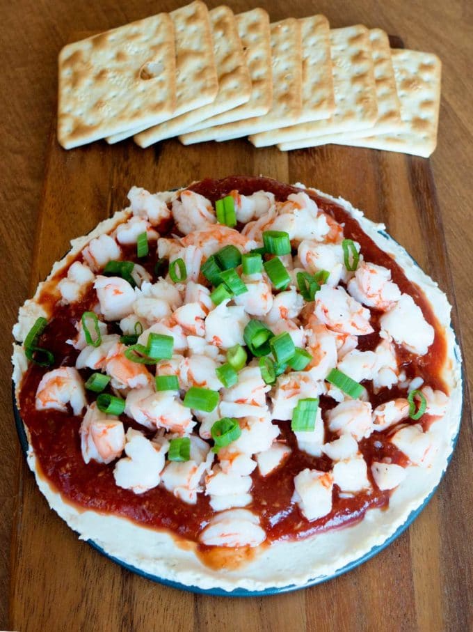 Game Day Snack, a Layered Shrimp Cocktail Spread with crackers.