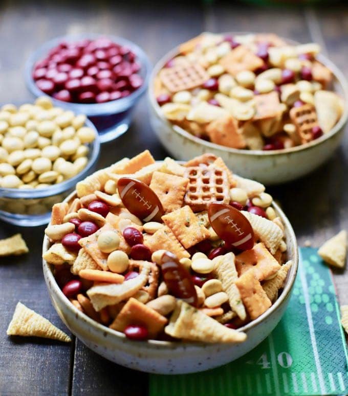 Tailgating snack two bowls of game day snack mix with football plastic picks. 