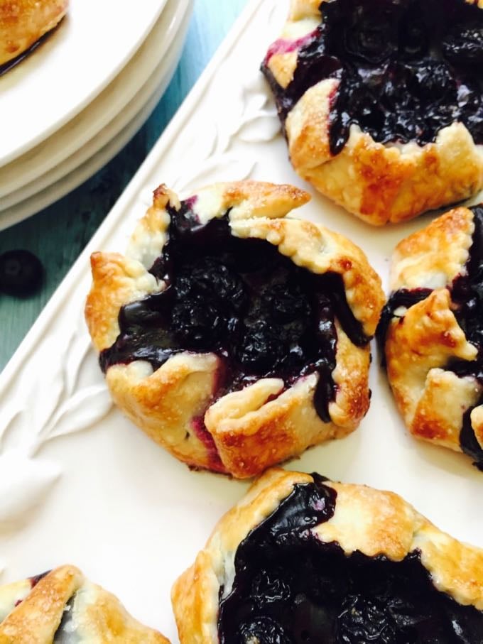 Easy Mini Blueberry Hand Pies on a plate ready for a back to school snack.