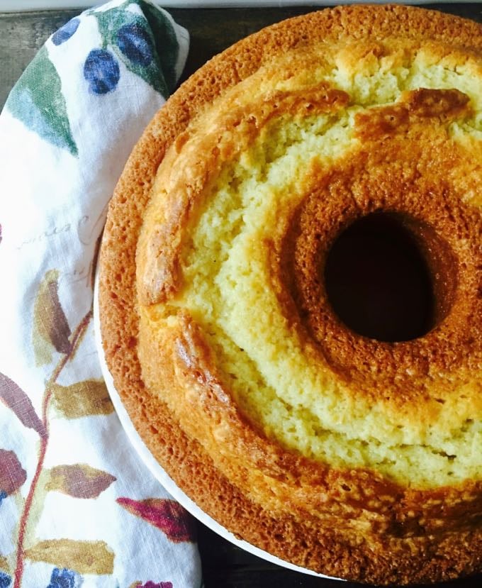 A whole pound cake out of the oven and ready to slice.