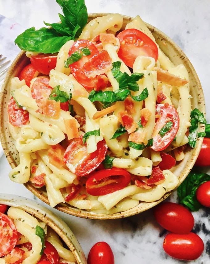 Yummy Pasta Salad with Green Goddess Dressing garnished with cherry tomatoes