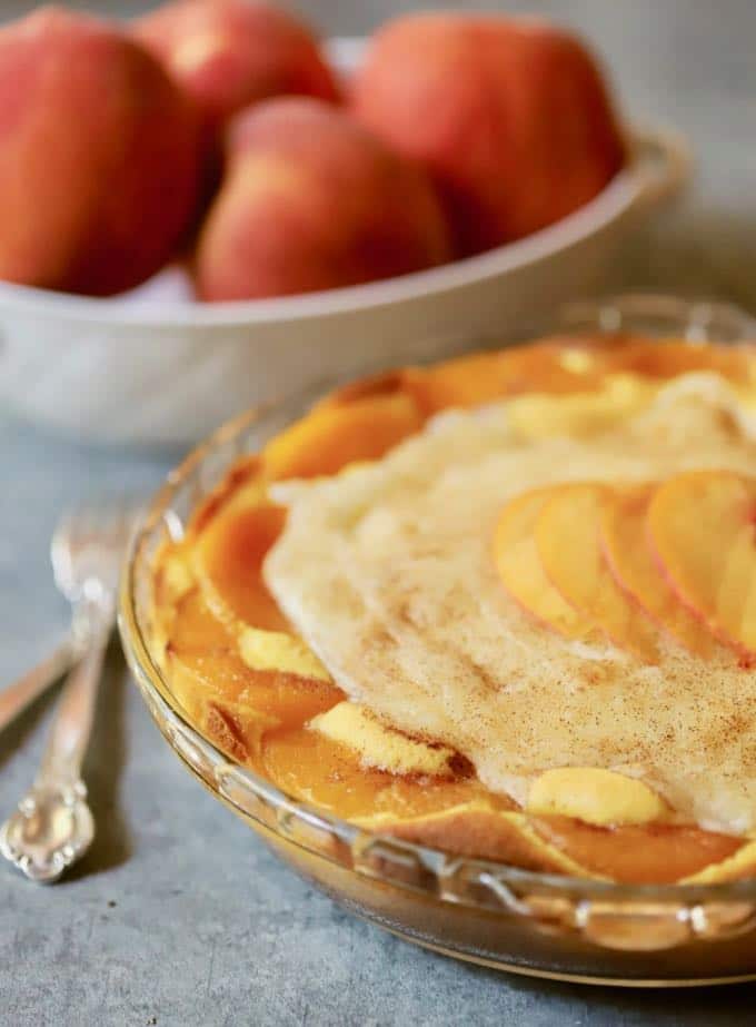 A peaches and cream pie in a clear glass pie plate.