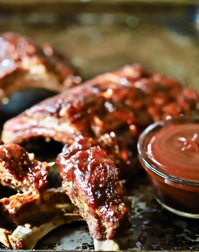 Best Oven Baked Baby Back Ribs slathered with BBQ sauce