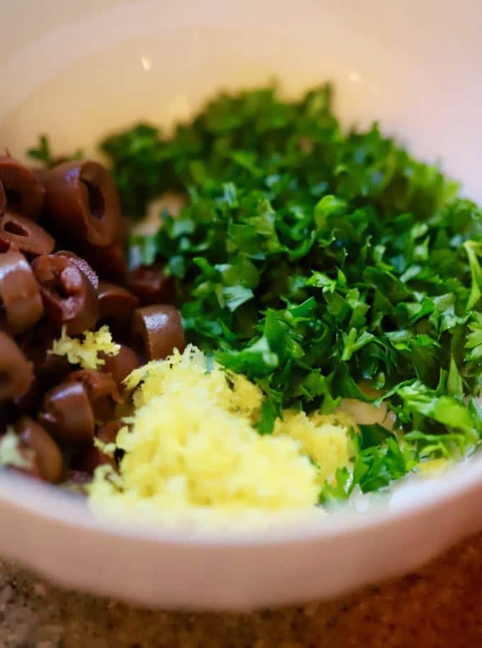 Slow Cooker Mediterranean Beef Roast combing the topping