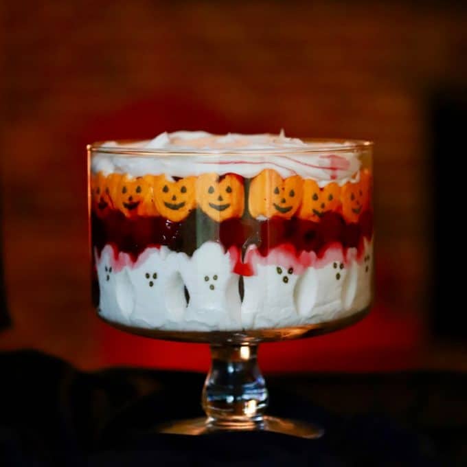 Halloween Black Forest Trifle in a clear trifle bowl with ghost and pumpkin peeps.