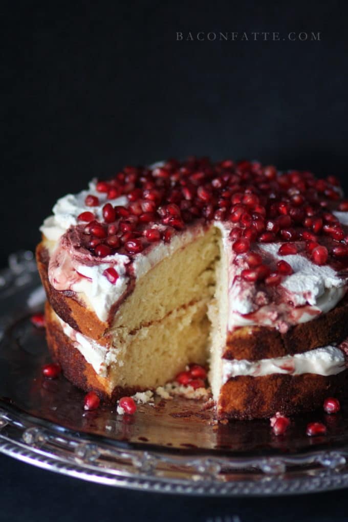 Amaretto Butter Cake topped with a whipped cream icing and pomegranate ariels. 