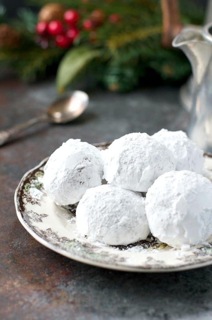 Bourbon Balls covered with powdered sugar on a plate. 