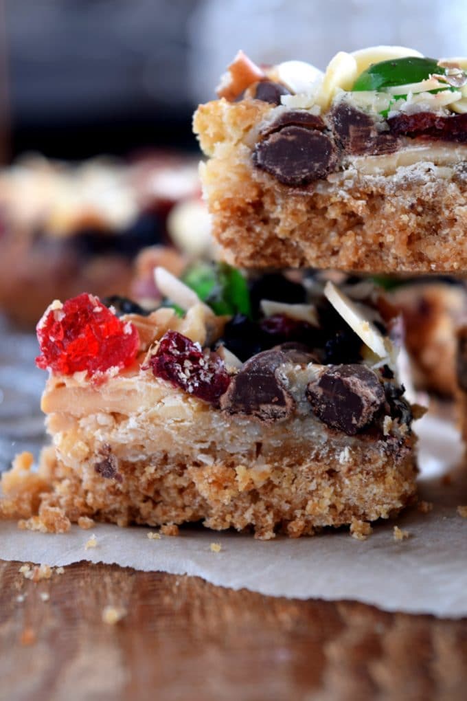 Christmas Jewel Squares stacked on a plate with assorted candied fruit.