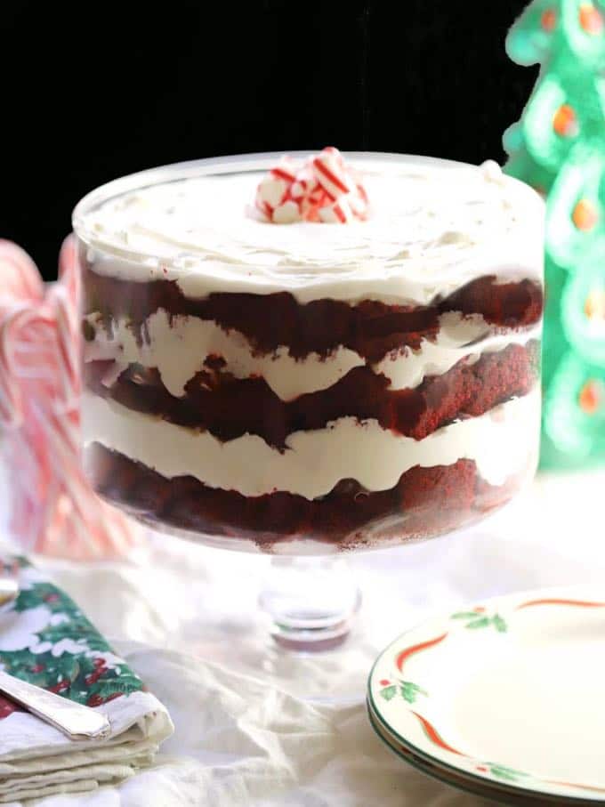 Christmas trifle with red velvet cake in a clear glass trifle dish.