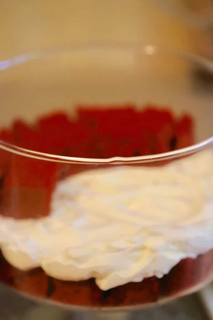 Adding the Cream Cheese Chipped Cream layer to Christmas Red Velvet Cake Trifle