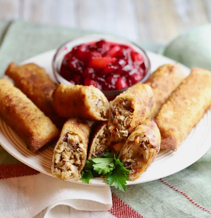 Easy Leftover Turkey Egg Rolls with Leftover Cranberry Sauce on a white plate. 