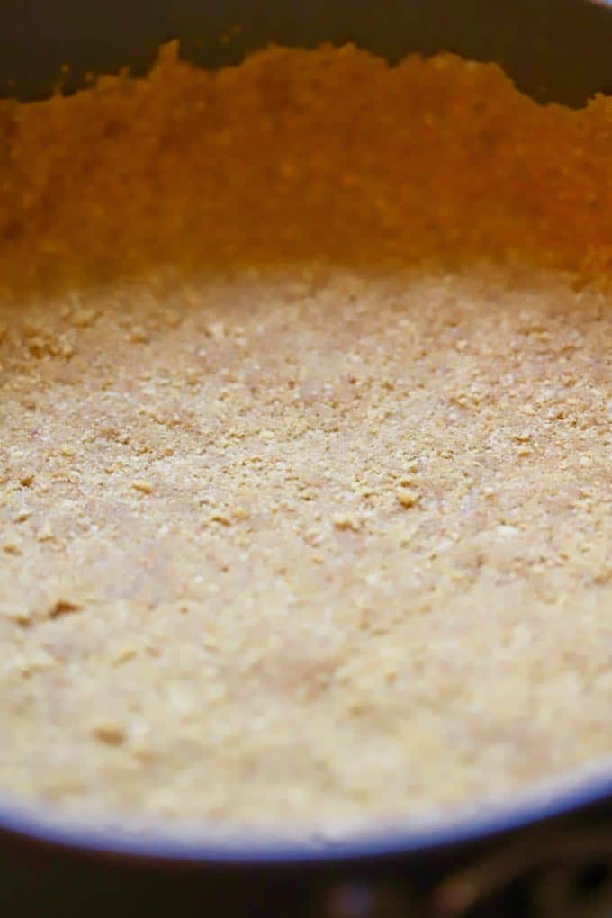 A graham cracker crust in a springform pan. 