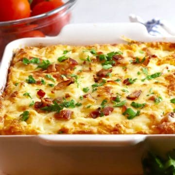 A white baking dish holding Cauliflower Cheese Bake casserole.