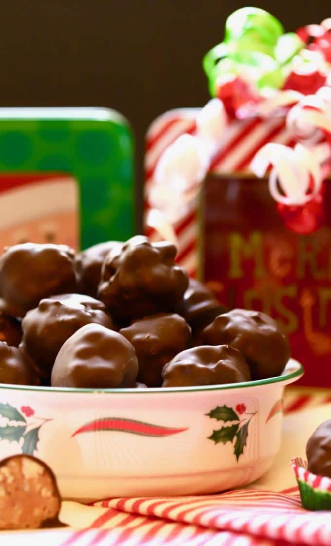 Billionaires candy in a Christmas bowl with gifts in the background.