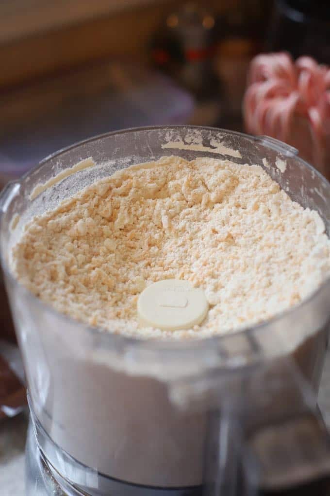 Processing the ingredients for Crispy Cheesy Southern Cheese Crackers in a food processor