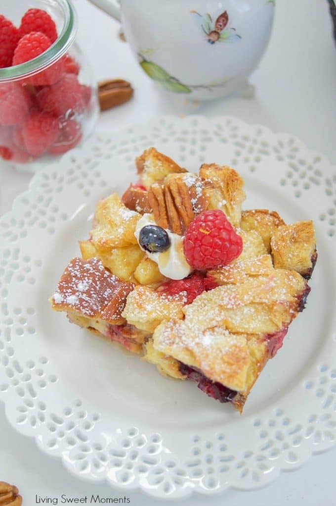 Overnight French Toast Casserole with a slice cut out on a white plate. 