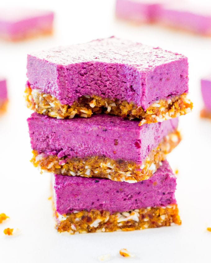 Raw Vegan Blackberry Cheesecake cut into squares and stacked.