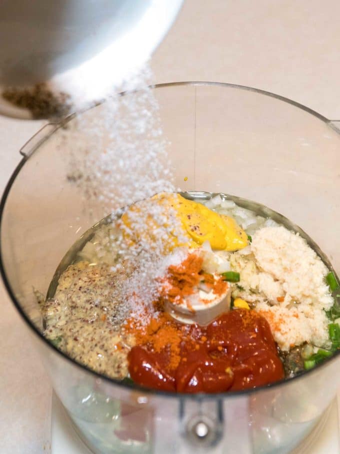 Adding all remoulade ingredients to a food processor for Spicy Shrimp Po' Boy Sandwiches