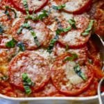 Fresh Tomato Casserole in a white baking dish with a spoon.