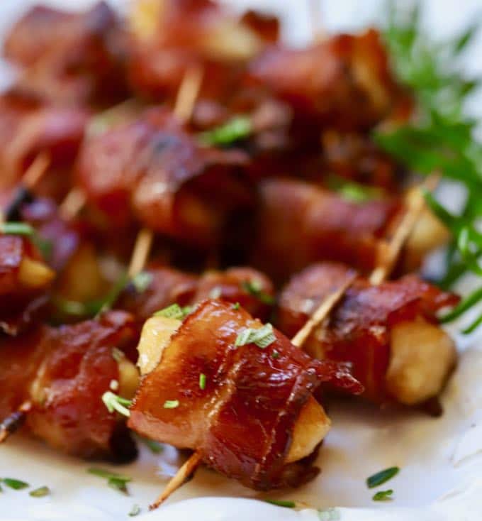 Easy Marinated bacon wrapped scallops with a garnish of chopped rosemary