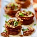 Healthy Roasted Sweet Potato Stacks topped with toasted pecans, scallions, and rosemary